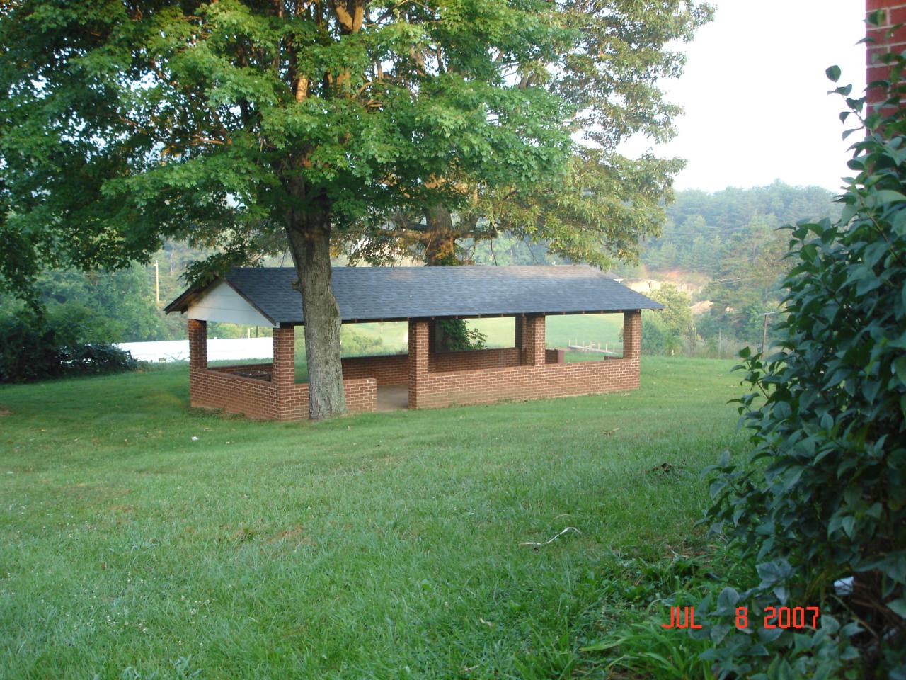 7469 Hardy Road Hardy, VA 24101 - Photo 5 of 7 a view of a house next to a big yard and large trees