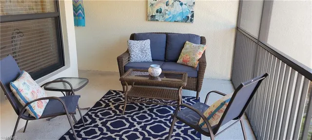 a view of a chairs and table in a balcony
