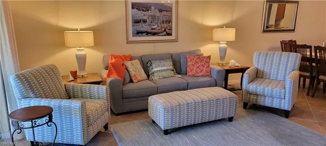 a living room with furniture and a lamp