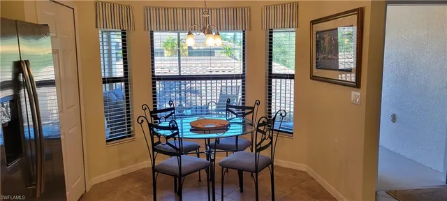 a view of a dining room with furniture and a window