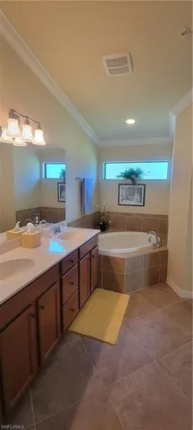a large bathroom with a sink mirror and a bath tub