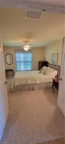 a bedroom with a bed and lamp