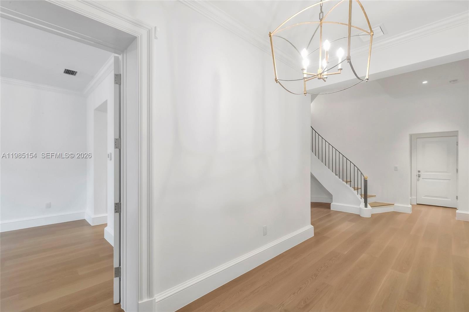 2613 Anderson Road, Unit 2613 Coral Gables, FL 33134 - Photo 11 of 96 a view of a hallway with wooden floor and staircase