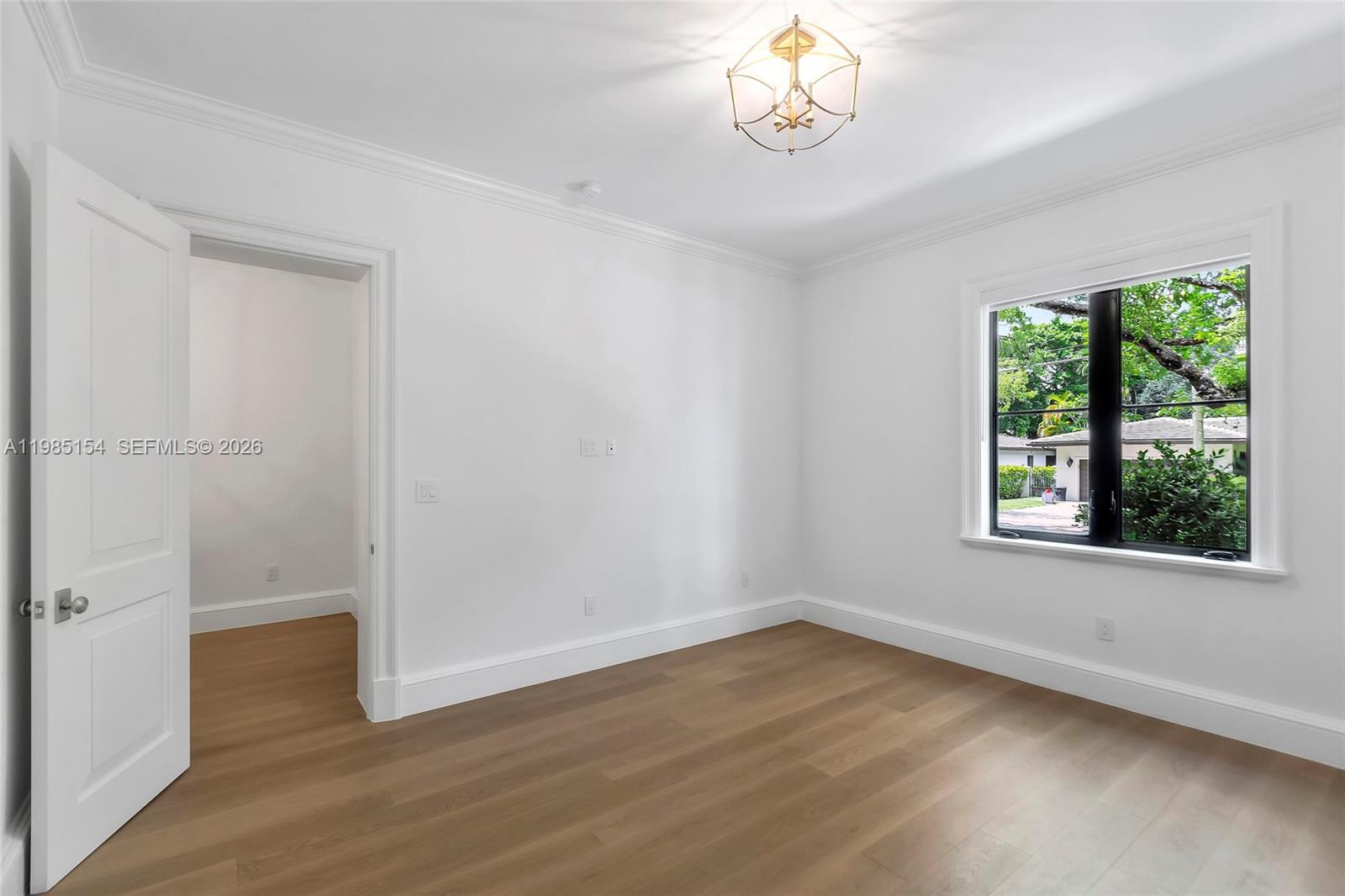 2613 Anderson Road, Unit 2613 Coral Gables, FL 33134 - Photo 16 of 96 an empty room with wooden floor and windows