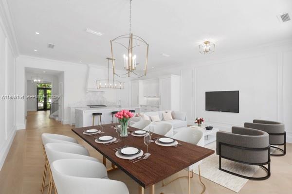 2613 Anderson Road, Unit 2613 Coral Gables, FL 33134 - Photo 33 of 96 a view of a dining room with furniture and wooden floor