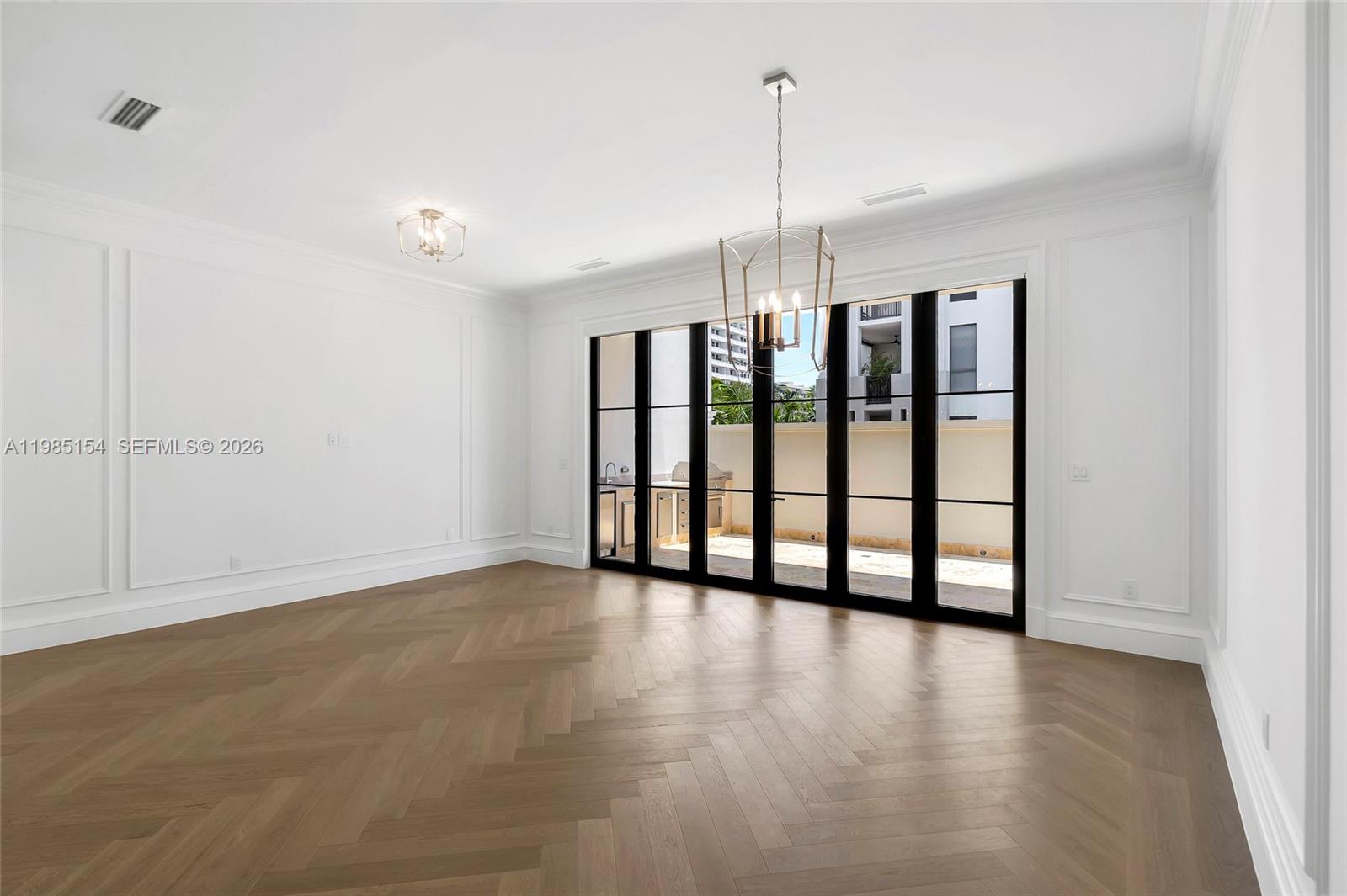 2613 Anderson Road, Unit 2613 Coral Gables, FL 33134 - Photo 37 of 96 a view of an empty room with window and hardwood floor