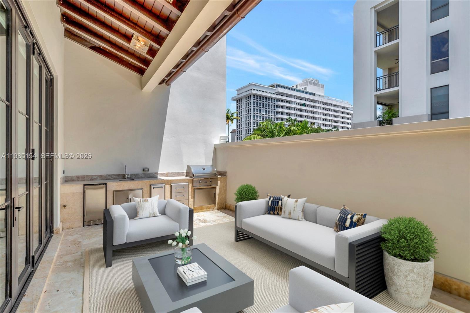 2613 Anderson Road, Unit 2613 Coral Gables, FL 33134 - Photo 40 of 96 a balcony with furniture and a potted plant