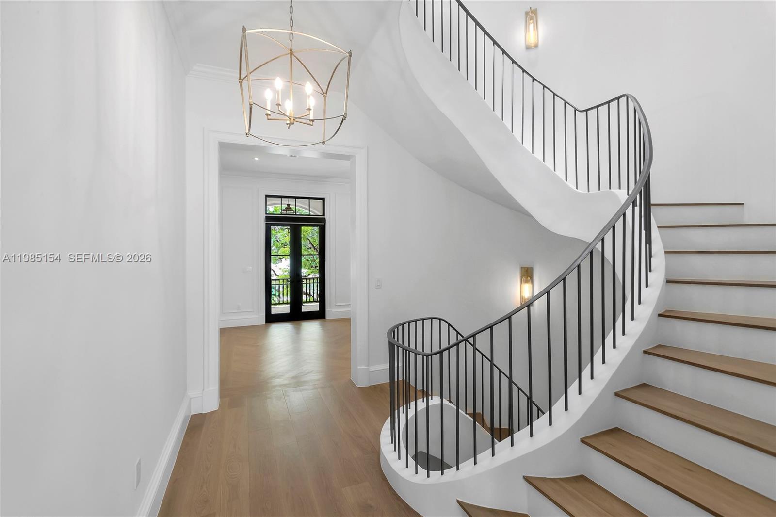 2613 Anderson Road, Unit 2613 Coral Gables, FL 33134 - Photo 47 of 96 a view of staircase with railing and a chandelier