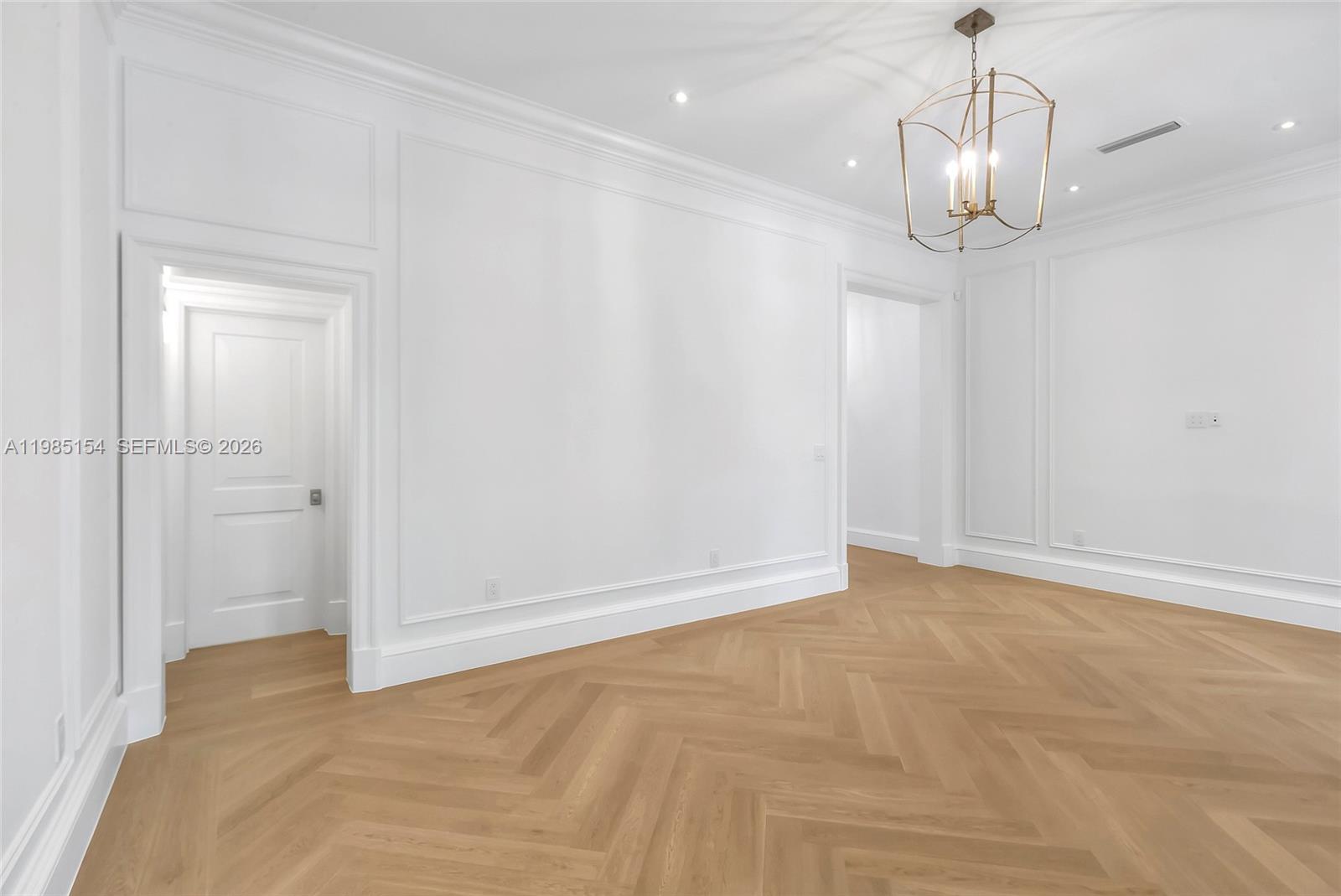 2613 Anderson Road, Unit 2613 Coral Gables, FL 33134 - Photo 56 of 96 a view of an empty room with wooden floor and a window