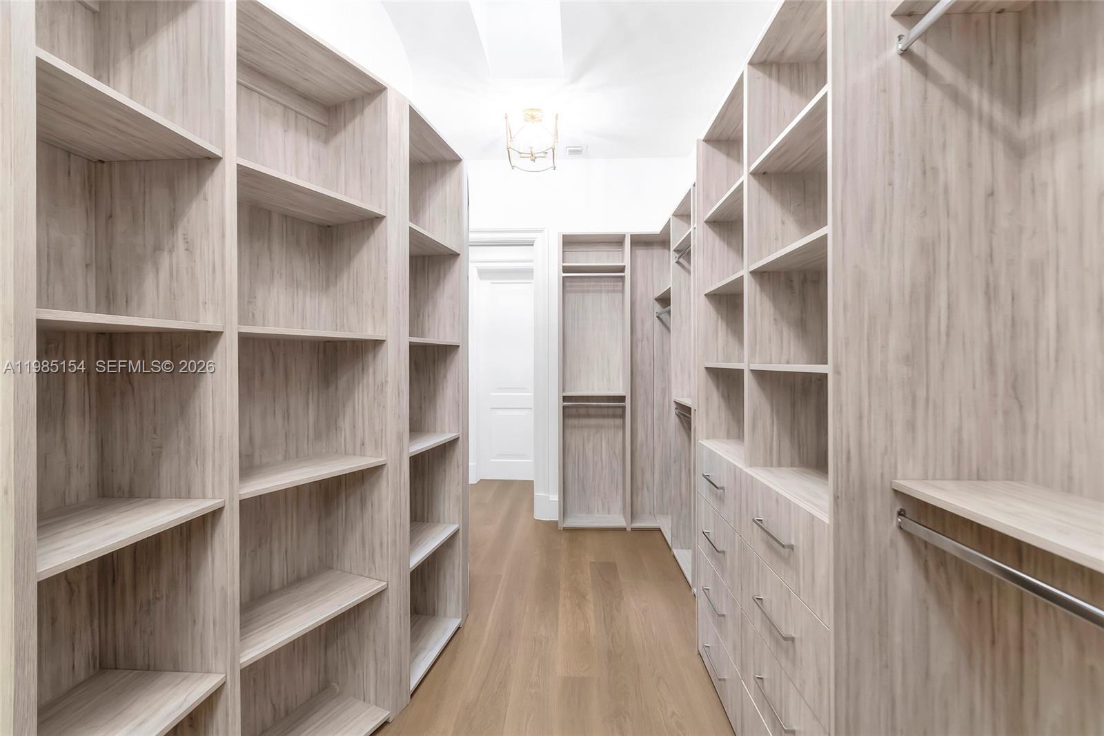 2613 Anderson Road, Unit 2613 Coral Gables, FL 33134 - Photo 74 of 96 a view of walk in closet with empty racks
