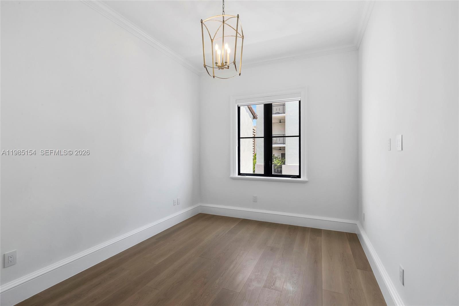 2613 Anderson Road, Unit 2613 Coral Gables, FL 33134 - Photo 82 of 96 an empty room with wooden floor and windows