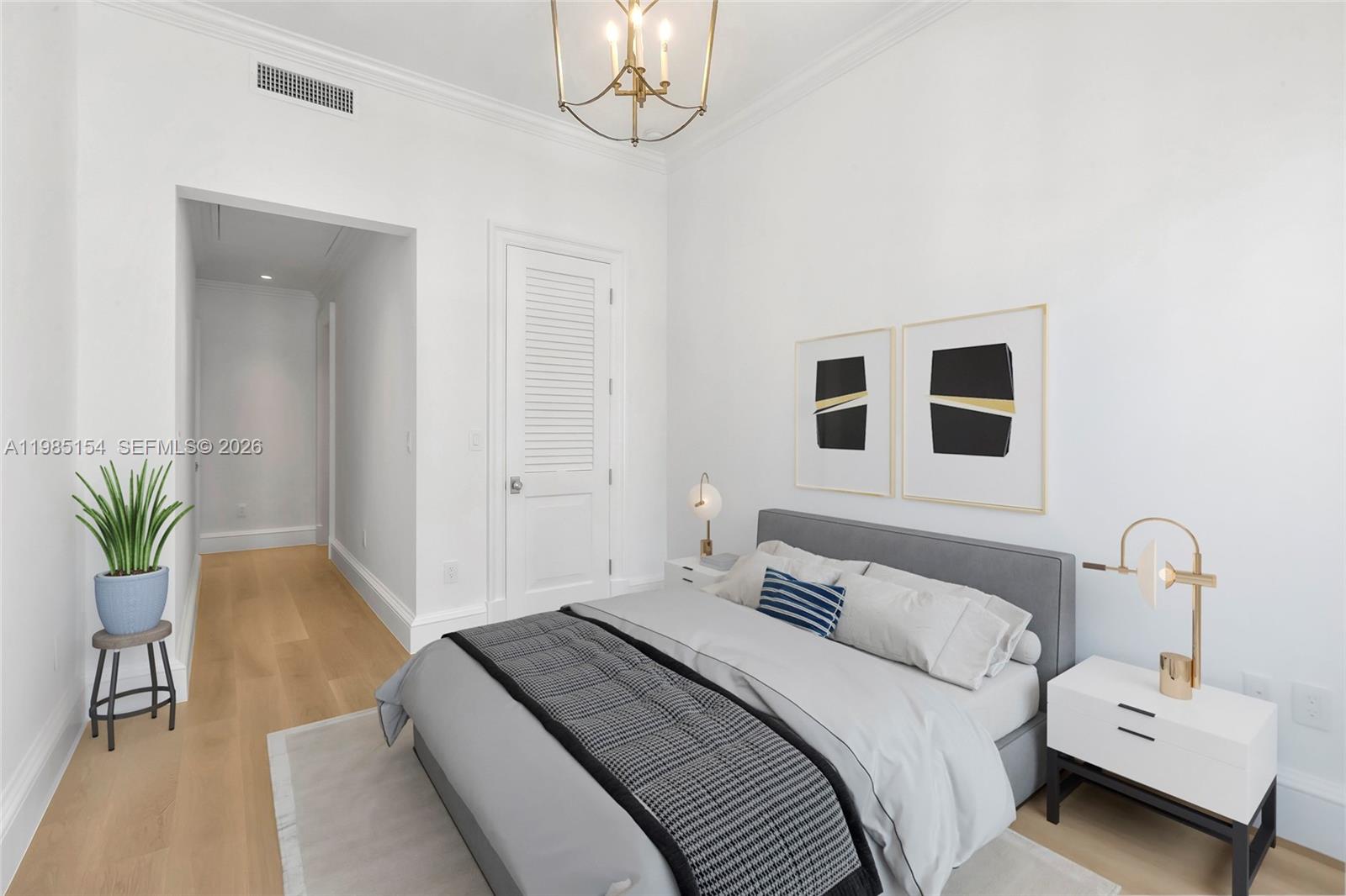 2613 Anderson Road, Unit 2613 Coral Gables, FL 33134 - Photo 83 of 96 a bedroom with a bed and a chandelier