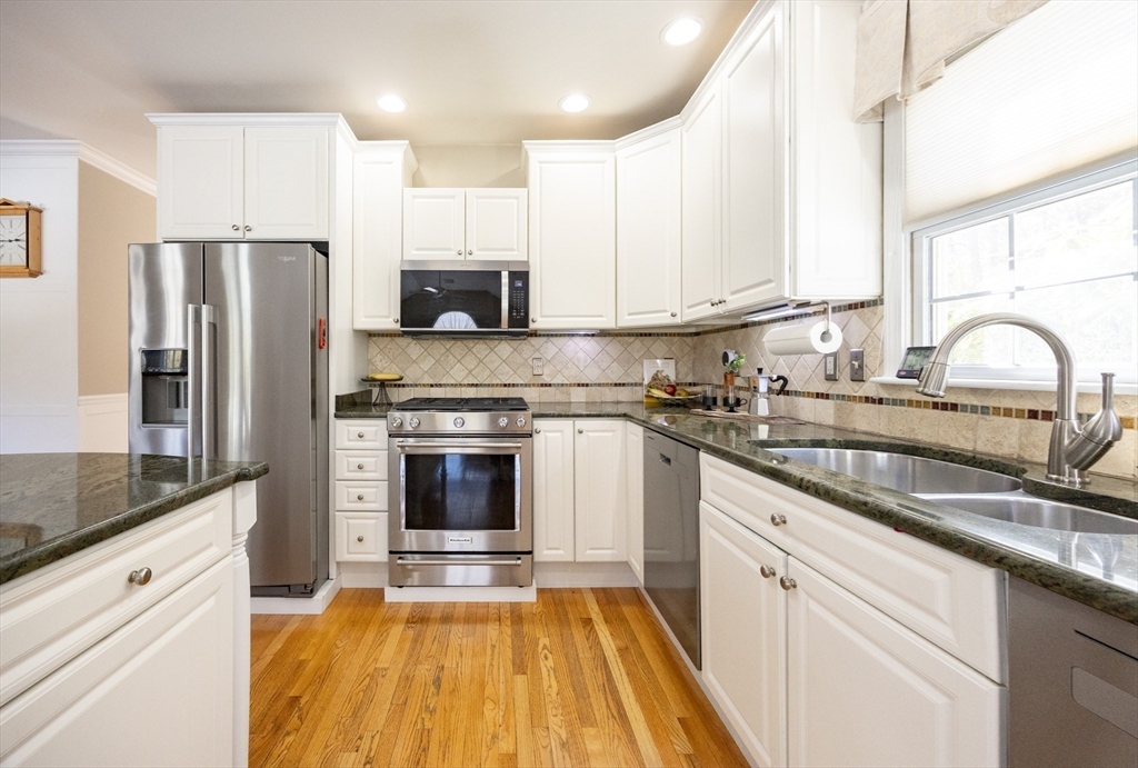 48 Laurel Drive Hudson, MA 01749 - Photo 11 of 42 a kitchen with granite countertop white cabinets and stainless steel appliances