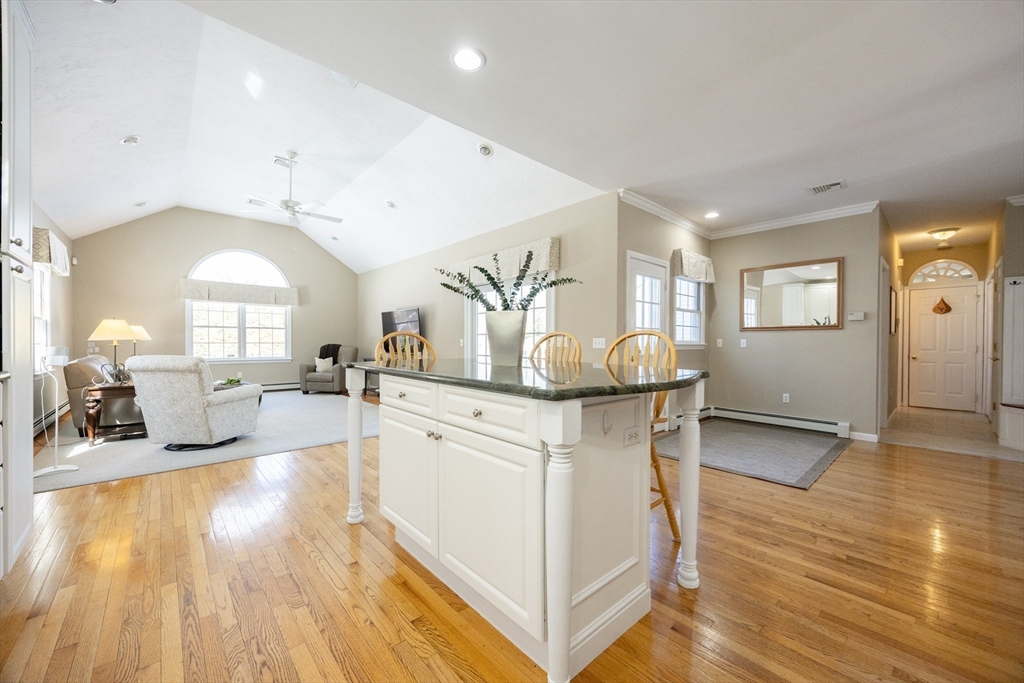 48 Laurel Drive Hudson, MA 01749 - Photo 13 of 42 a kitchen with stainless steel appliances granite countertop a stove a sink dishwasher and a refrigerator with wooden floor