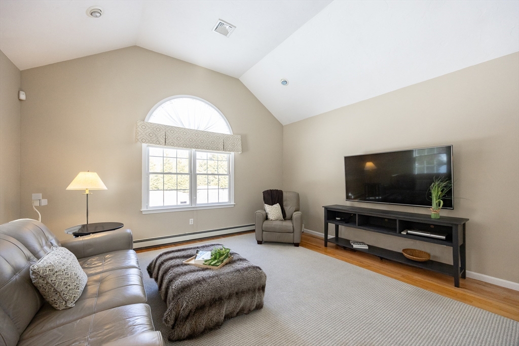 48 Laurel Drive Hudson, MA 01749 - Photo 17 of 42 a living room with furniture and a flat screen tv