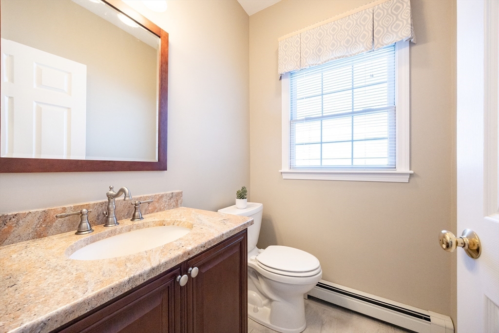 48 Laurel Drive Hudson, MA 01749 - Photo 19 of 42 a bathroom with a granite countertop sink toilet and mirror