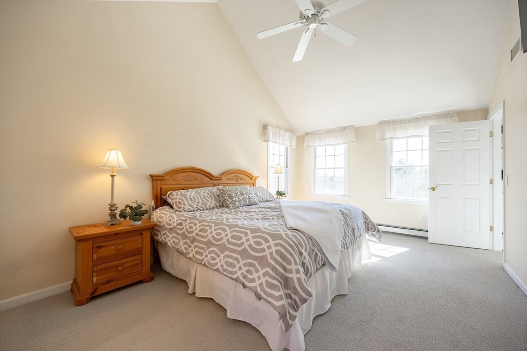 48 Laurel Drive Hudson, MA 01749 - Photo 24 of 42 a bedroom with a bed and a chandelier