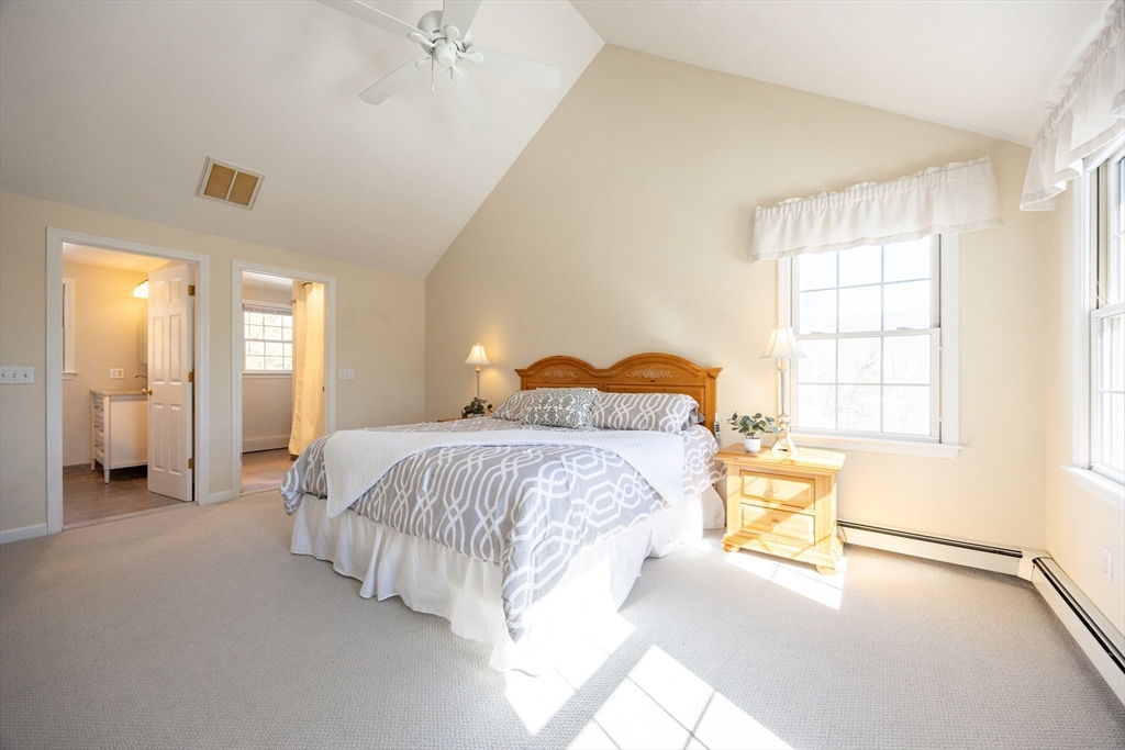 48 Laurel Drive Hudson, MA 01749 - Photo 25 of 42 a spacious bedroom with a bed and a chandelier