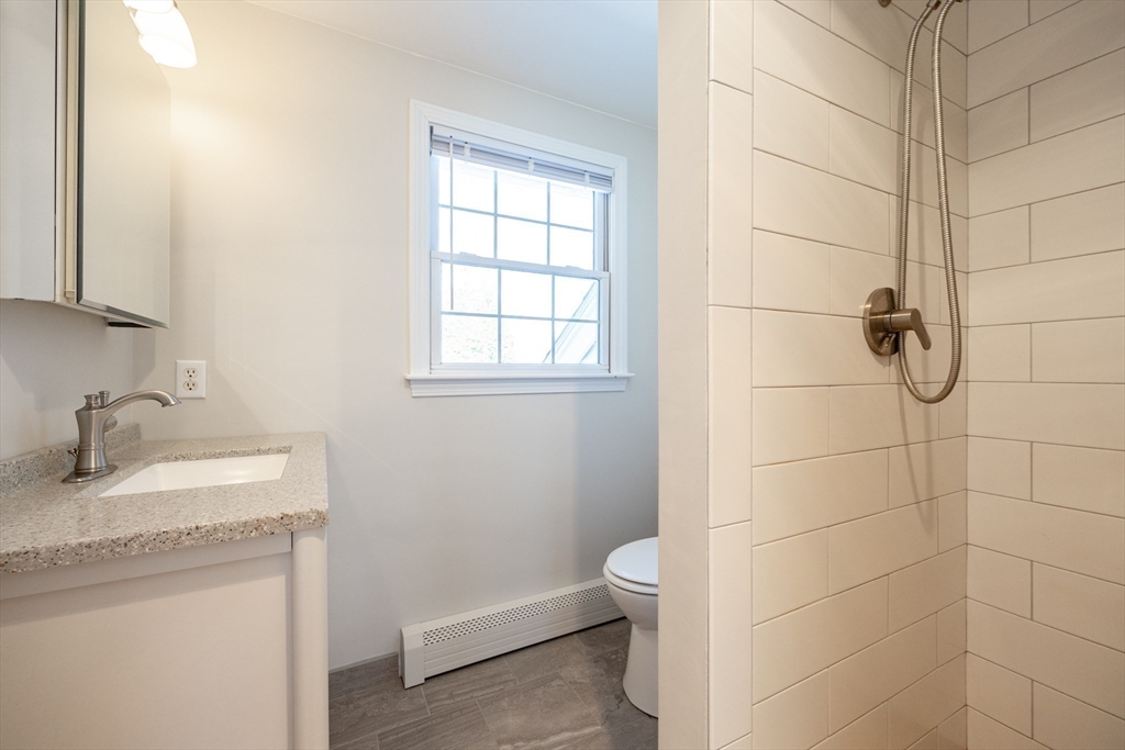 48 Laurel Drive Hudson, MA 01749 - Photo 27 of 42 a bathroom with a granite countertop sink toilet and shower
