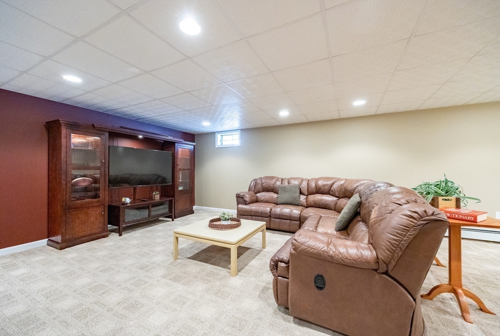 48 Laurel Drive Hudson, MA 01749 - Photo 32 of 42 a living room with furniture and a flat screen tv