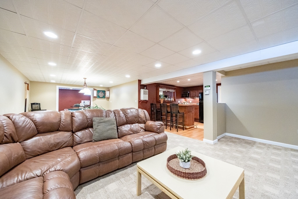 48 Laurel Drive Hudson, MA 01749 - Photo 33 of 42 a living room with furniture a table and kitchen view