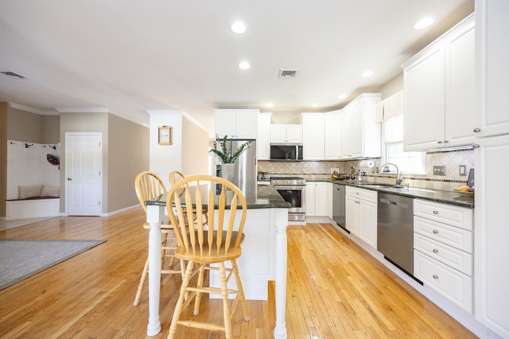 48 Laurel Drive Hudson, MA 01749 - Photo 10 of 42 a kitchen with granite countertop a center island stainless steel appliances cabinets and a window