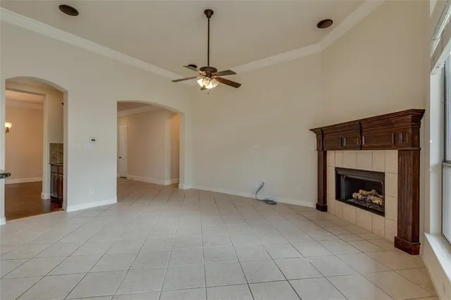 an empty room with fan and fireplace