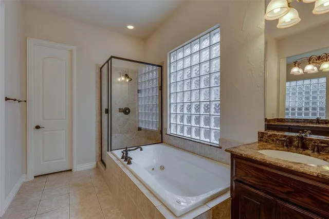 a bathroom with a tub sink and mirror
