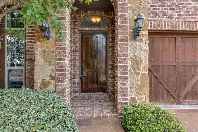 a view of a brick house with a door and a large window
