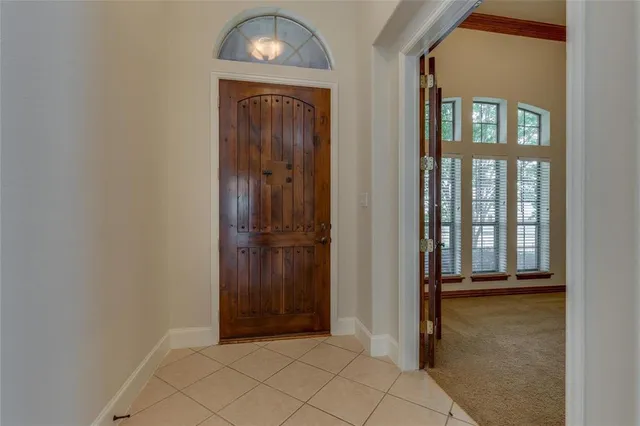 an entryway door with wooden floor