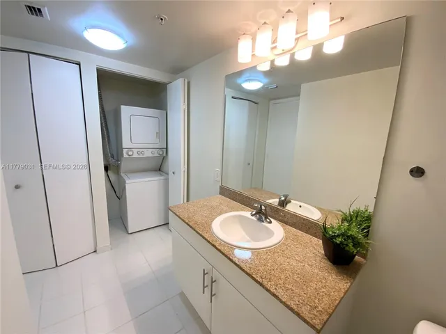 a bathroom with a sink a vanity and mirror