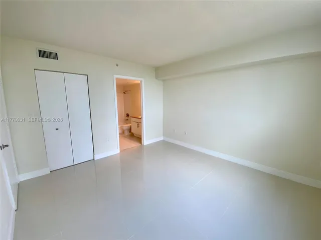 a view of an empty room and closet area