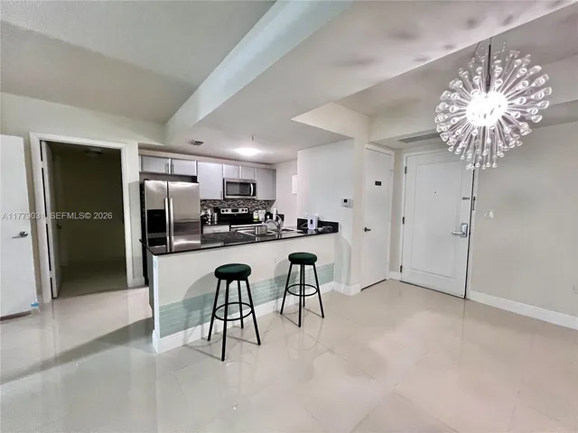 a view of kitchen with furniture and refrigerator