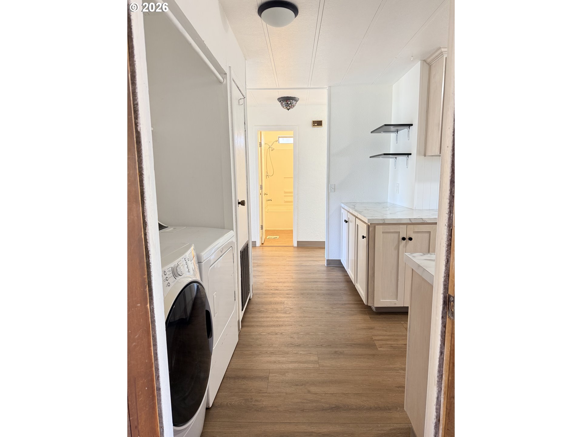 1330 West Sunland Avenue Hermiston, OR 97838 - Photo 22 of 23 a view of a hallway with washer and dryer