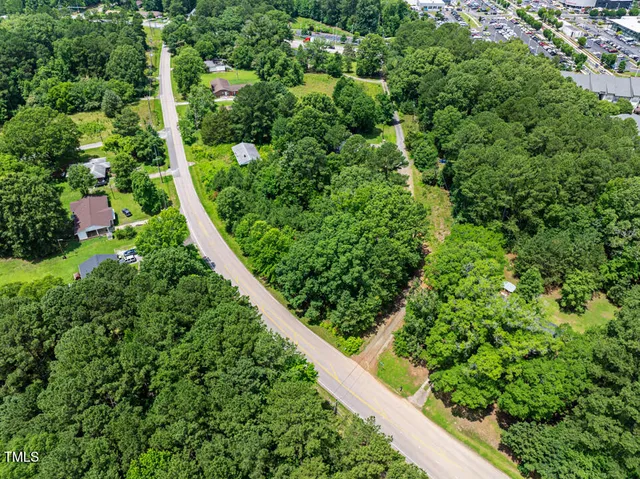 an aerial view of residential houses with outdoor space and river