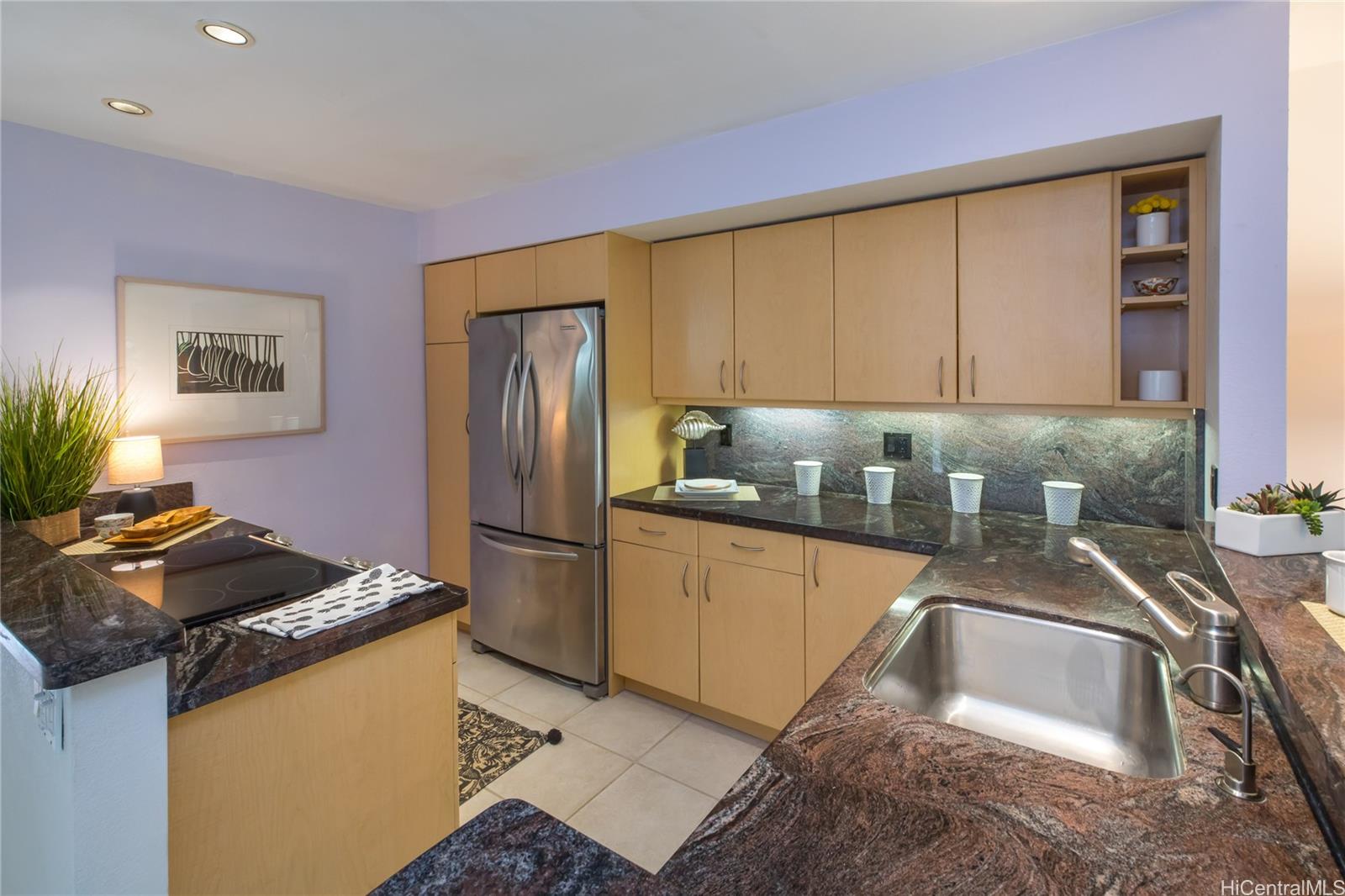 445 Kawailoa Road, Unit 4 Kailua, HI 96734 - Photo 7 of 23 a kitchen with granite countertop a sink stove and refrigerator