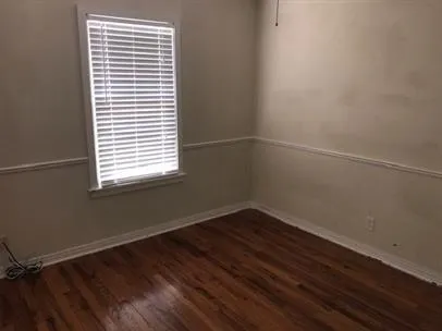 a bathroom with a toilet and a mirror