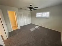 a kitchen with a sink a counter space and a chandelier
