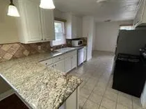 a view of a room with wooden floor and electronic appliances