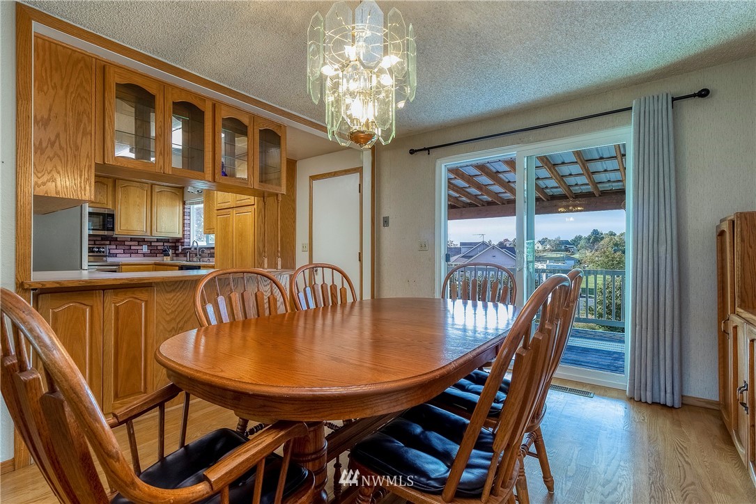 356 Bussell Road Walla Walla, WA 99362 - Photo 14 of 34 a dining room with furniture a chandelier and wooden floor