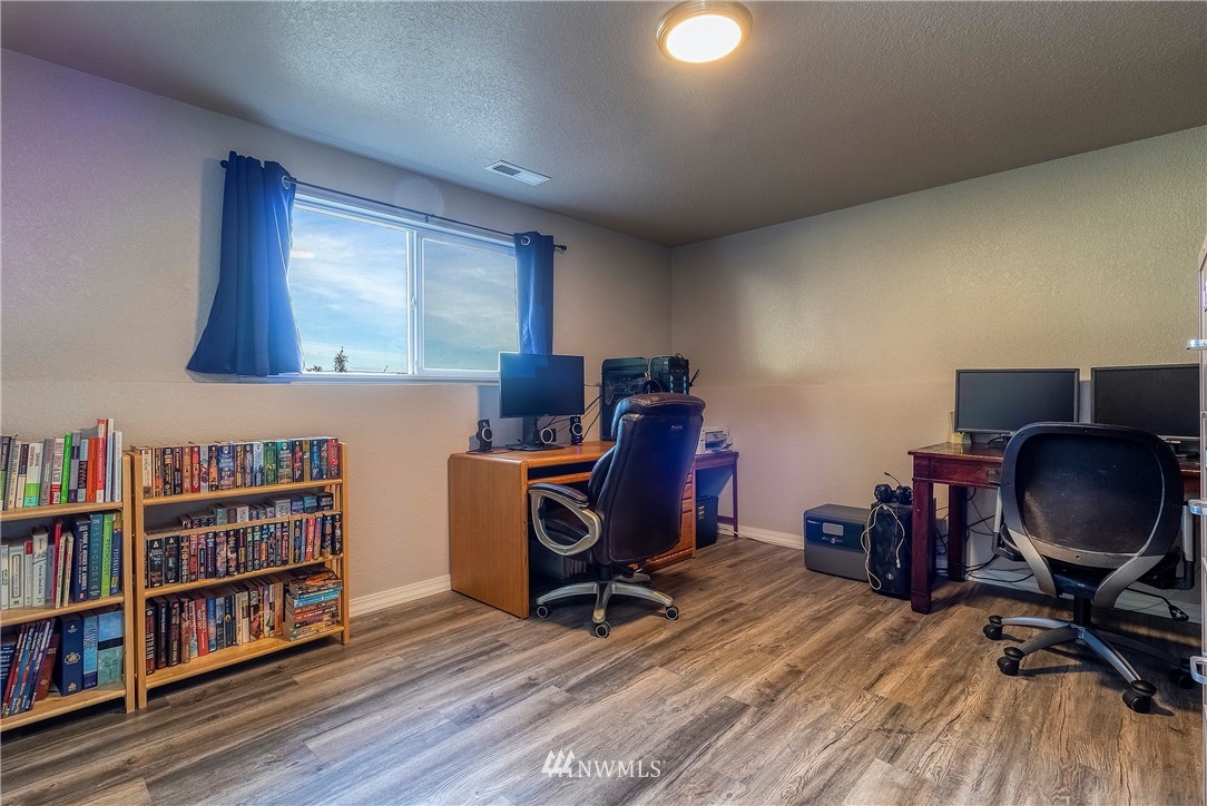 356 Bussell Road Walla Walla, WA 99362 - Photo 23 of 34 a view of a workspace with furniture and a book shelf