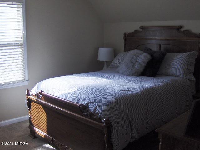 5771 Wakefield Way Macon, GA 31210 - Photo 13 of 34 a bed sitting in a bedroom next to a window