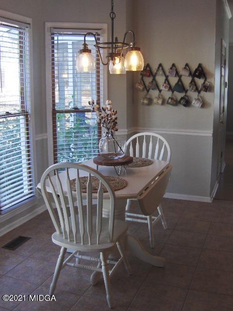 5771 Wakefield Way Macon, GA 31210 - Photo 8 of 34 a view of a dining room with furniture and chandelier