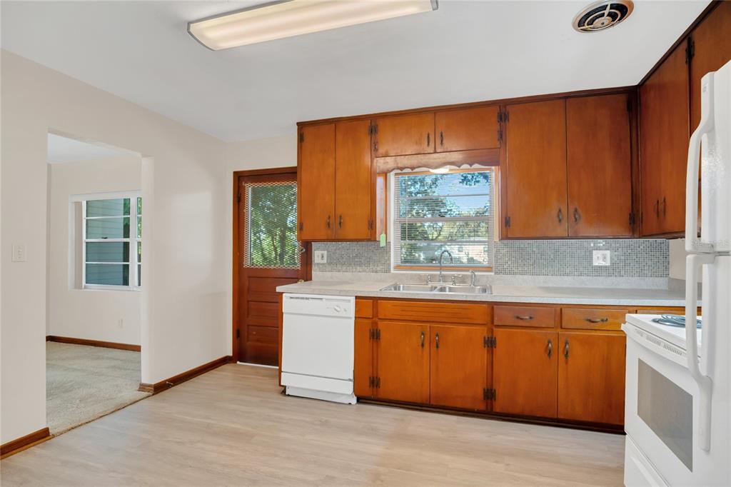 2807 Nancy Street Orlando, FL 32806 - Photo 11 of 27 a kitchen with stainless steel appliances granite countertop a stove a sink and a microwave