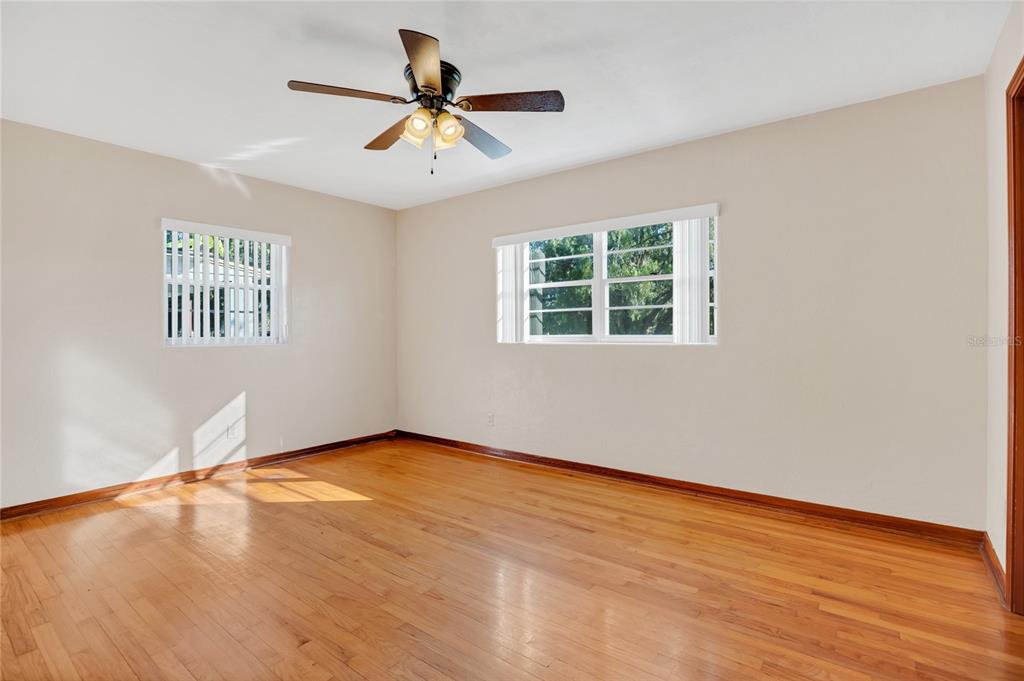 2807 Nancy Street Orlando, FL 32806 - Photo 15 of 27 an empty room with wooden floor and windows