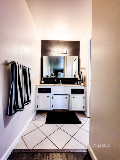 521 Sydnor Avenue Ridgecrest, CA 93555 - Photo 21 of 28 a bathroom with a sink and a mirror