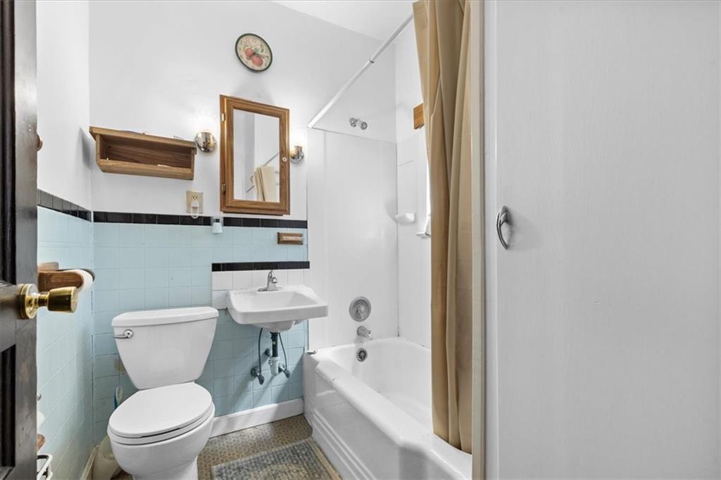 115 Meade Avenue Pittsburgh, PA 15202 - Photo 16 of 27 a bathroom with a toilet a sink and a bathtub