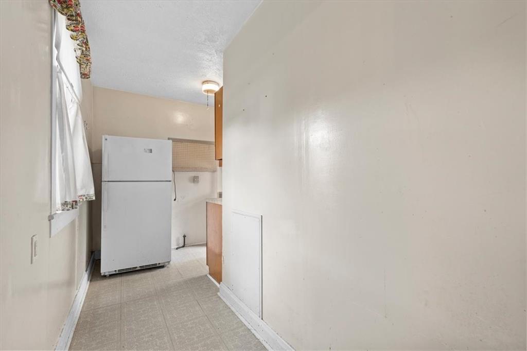 115 Meade Avenue Pittsburgh, PA 15202 - Photo 20 of 27 a view of a hallway with a refrigerator