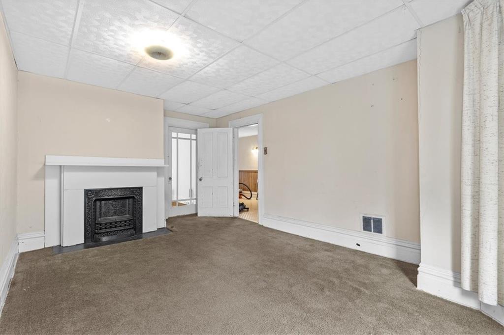 115 Meade Avenue Pittsburgh, PA 15202 - Photo 23 of 27 a view of empty room with a fireplace