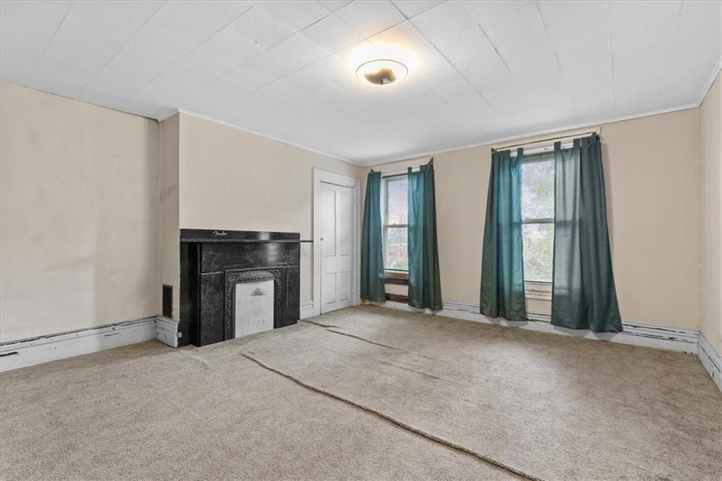 115 Meade Avenue Pittsburgh, PA 15202 - Photo 24 of 27 an empty room with windows and fireplace